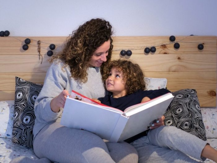 Mother reads to child in preparation for bedtime.