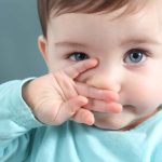 Newborn scratches nose do to nasal irritation.
