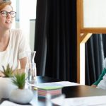 Group of diverse young professionals meeting at table