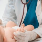 pediatrician examining newborn