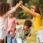 Large group of school kids having fun in nature.