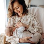 parent working with child to breastfeed